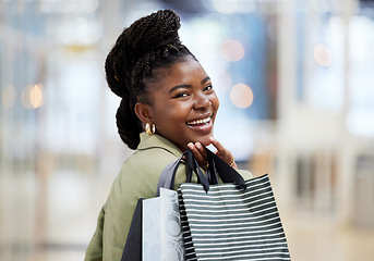 Image showing Black woman, shopping bag and portrait smile for discount, payment or sale in fashion at retail mall or store. Happy African female person or shopper smiling with gift bags, products or purchase