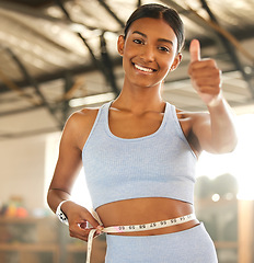 Image showing Measure, lose weight or happy woman with thumb up or tape for waist or body goals in fitness studio. Gym, thumbs up or healthy girl measuring her stomach for goal progress, training or motivation