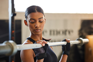 Image showing Fitness, Indian woman or bodybuilder with a barbell in training, workout or exercise for body building. Girl, mindset or healthy athlete weightlifting powerlifting with focus at gym club studio