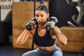 Image showing Fitness, squat or woman with dumbbells training, exercise or workout for powerful arms or muscles in gym. Dumbbell squats, bodybuilder or Indian girl athlete lifting weights or exercising biceps