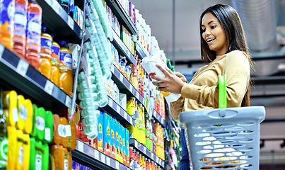 Image showing Grocery, shopping and wow with woman in supermarket for food, retail or label reading. Product, nutrition and health with female customer and basket in store for diet, discount and sale coupon