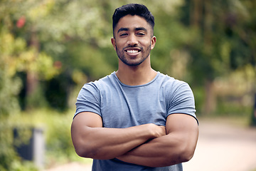 Image showing Portrait, fitness and man with arms crossed, outdoor and exercise for wellness, training and workout goal. Face, male person or athlete with health, motivation or sports in a park, happiness and calm