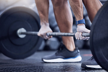 Image showing Man, training and hands with weight in a closeup at the club for workout with equipment. Male trainer, barbell and lifting with hand on the floor at a gym for strength with muscles for exercise.