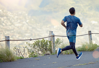 Image showing Man running in road, fitness and cardio outdoor, exercise and healthy, active lifestyle with back. Male runner on path to run, train for marathon with speed, energy and workout for health and sport