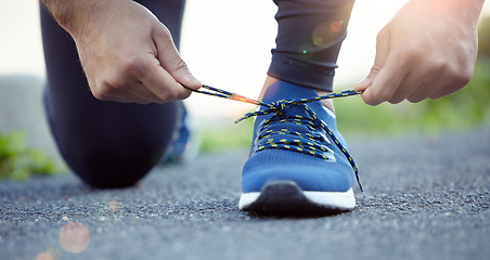 Image showing Shoes, hands and man tying shoelace for run, fitness outdoor for exercise, cardio and active with health and closeup. Sports, running sneakers and male person start workout with bokeh and training