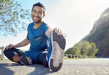 Image showing Exercise, portrait and stretching with a man runner outdoor in the mountains for a cardio or endurance workout. Fitness, sports and smile with a young male athlete getting ready for a run in nature