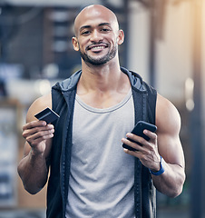 Image showing Ecommerce, portrait of man with smartphone and credit card at the gym with a lens flare. Health wellness, workout and happy male athlete with cellphone for online shopping with bank information