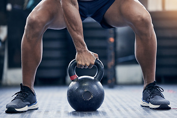 Image showing Fitness, floor and kettlebell with a bodybuilder man in the gym for a weightlifting workout routine. Exercise, hand and strong with a male athlete holding a weight in a sports club while training