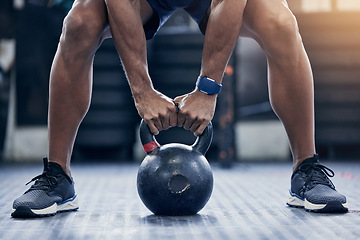 Image showing Exercise, floor and kettlebell with a bodybuilder man in the gym for a weightlifting workout routine. Fitness, hands and strong with a male athlete holding a weight in a sports club while training