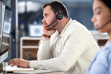 Image showing Mental health, man with headset and computer at his desk in a modern office at workplace. Telemarketing or online communication, customer service and male call center agent bored at his workstation