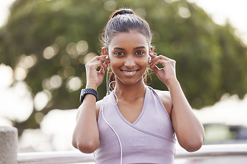 Image showing Fitness, portrait of happy woman with earphones in park on workout break listening to music or podcast. Exercise, training and girl with headphones for radio streaming service while running in nature