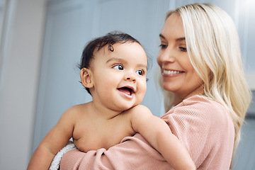 Image showing Love, smile and mother holding with her baby in the nursery room of their modern family home. Happy, bonding and young woman hugging her cute girl infant child with care and affection in their house.