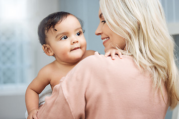 Image showing Bonding, love and mother holding her baby in the nursery room of their modern family home. Happiness, smile and young woman hugging a cute girl infant child with care and affection in their house.