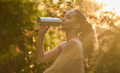 Image showing Fitness, woman and drinking water in nature for sustainability, healthy wellness or break from exercise. Calm female person, athlete or runner with drink for hydration after cardio workout in forest