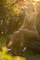 Image showing Fitness, woman and drinking water in nature on break for sustainability, healthy wellness or exercise. Calm female person, athlete or runner with drink for hydration after cardio workout in forest