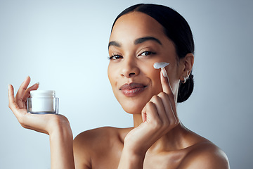 Image showing Face cream, skincare and woman in studio for dermatology, wellness and hydration on grey background. Portrait, sunscreen and lady model relax with collagen, mask and lotion, beauty or facial product