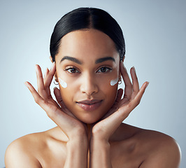 Image showing Hands, face cream and woman skincare in studio for dermatology, wellness or anti aging on grey background. Portrait, sunscreen and lady model relax with collagen, mask and lotion, beauty or facial