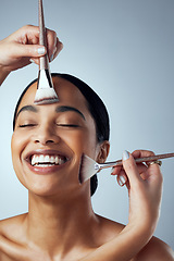 Image showing Makeover, hands and woman with makeup brush in studio for change, glamour and cosmetic against grey background. Beauty, tools and happy female model smile for foundation, contour or transformation