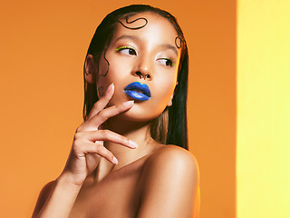 Image showing Cosmetics, blue lipstick and face of woman in studio for makeup, eye shadow and beauty salon. Creative aesthetic, cosmetology and female person with neon color for glamour, luxury style and glow