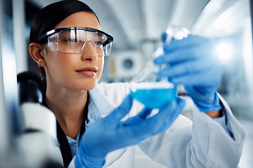 Image showing Woman, scientist and study chemical liquid, glass beaker and science chemistry experiment in lab. Female doctor with goggles, gloves and analysis of fluid, scientific innovation and medical research