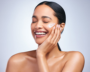 Image showing Beauty cream, woman and skincare smile with dermatology and face cleaning. Wellness, cosmetic lotion and young female model with skin glow product and treatment with care and laugh in studio