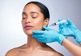 Image showing Woman, studio and gloves with needle, surgery or cosmetics for skin, facial or collagen by white background. Girl cosmetic surgeon and filler on face, syringe or hands for beauty, skincare or change