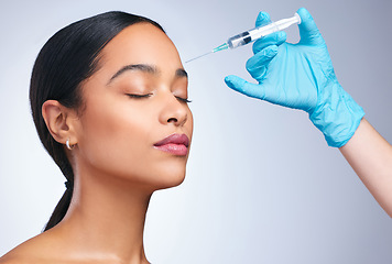 Image showing Woman, studio and gloves for injection, surgery or cosmetics for skin, facial or collagen by white background. Girl cosmetic surgeon and filler on face, needle or hands for beauty, skincare or change