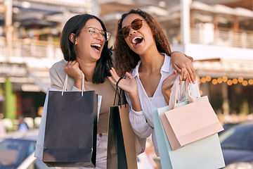 Image showing Happy, women friends with shopping bags and at street in city with a smile. Promotion or discount, happiness or retail and excited or cheerful female people shop together for fashion products