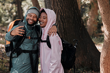 Image showing Happy, black couple and hiking in hug for selfie, profile picture or vlog in travel adventure in nature. African man and woman hiker hugging for photo, memory or social media and trekking in forest