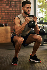 Image showing Squat, fitness and man with kettle bell in gym for exercise, bodybuilder training and workout. Sports, strong muscle and serious male person lifting weight for wellness, healthy body and strength