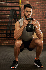 Image showing Bodybuilder, fitness and man with kettle bell in gym for exercise, strength training and workout. Sports, challenge and serious male person squat with weights for wellness, healthy body and muscles