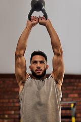 Image showing Muscle, fitness and man focus with kettlebell in gym for exercise, bodybuilder training and workout. Sports, strength and serious male person lift weight for wellness, healthy body and power