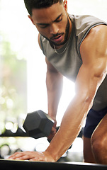 Image showing Exercise, weightlifting and man with dumbbell in gym for fitness, bodybuilder training and workout. Sports, strong muscles and serious male person lift weights for wellness, healthy body and strength