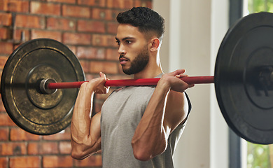 Image showing Weightlifting, workout and man with barbell in gym for exercise, bodybuilder training and fitness. Sports, muscles and serious male person lifting weights for wellness, strong body and strength