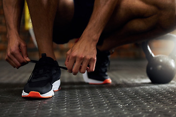 Image showing Tie shoes, man hands and gym floor for fitness, strength training and exercise. Athlete feet, sport routine and male person prepare to start workout and wellness class at health center with sneakers