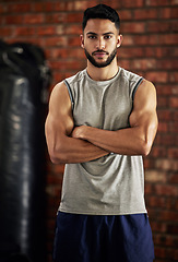 Image showing Fitness, muscle and portrait of man in gym with arms crossed for confidence, motivation and pride. Exercise, workout and serious face of confident bodybuilder, personal trainer or sports club owner.