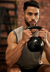 Image showing Weightlifting, training and man with kettle bell in gym for exercise, bodybuilder and fitness workout. Sports, muscle and serious male person squat with weight for wellness, healthy body and strength