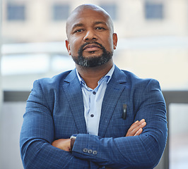 Image showing Confidence, crossed arms and portrait of a businessman in his office with a serious face expression. Career, professional and confident African male executive ceo posing in the modern workplace.