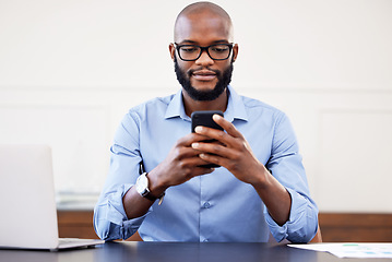 Image showing Black man, phone and desk in office with search on internet for networking, email or social media. Online research, digital marketing and businessman with glasses, cellphone and laptop at start up.