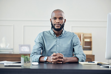 Image showing Business, portrait and black man at desk in office, startup or entrepreneur focus on planning, strategy and career. Businessman, working and confident mindset, motivation and commitment to company