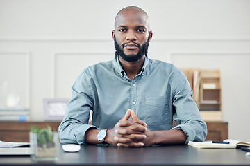 Image showing Portrait, business and black man at desk in office, startup or entrepreneur focus on planning, strategy and career. Businessman, working and confident mindset, motivation and commitment to company