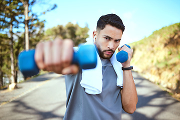 Image showing Man, dumbbell and punches in nature fitness for exercise, workout or training in the outdoors. Portrait of fit, active and sporty male person punching with weights in healthy outdoor cardio endurance