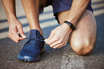 Image showing Man, hands and tying shoes for running, fitness or cardio exercise on asphalt road in the outdoors. Hand of male person, athlete or runner tie shoe getting ready for exercising or training on street