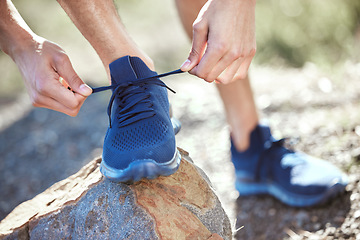 Image showing Man, hands and tie shoes for running, fitness or getting ready for workout, hiking or walk in nature. Hand of male person, hiker or runner tying shoe for trekking, run or cardio exercise outdoors