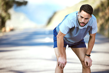 Image showing Fitness, man and tired outdoor with music on a run or workout with earphones. Male athlete person or runner listening to audio on a road for cardio training, running or exercise break to breathe