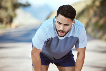 Image showing Fitness, tired man and outdoor with earphones for music on run or workout. Exhausted athlete person or runner listening to audio on break and road for exercise, running and training or breathing