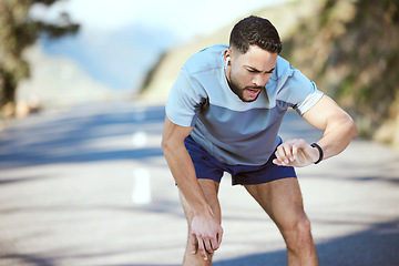 Image showing Man, fitness and outdoor with a watch for a run or exercise with performance progress. Tired athlete person or runner on a road with time and music for training, running or health and wellness goals