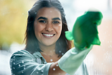 Image showing Housekeeping, portrait and cleaner cleaning the window with a cloth by her home or apartment. Female maid, housekeeper or wife washing the glass door with detergent product for bacteria, dirt or dust