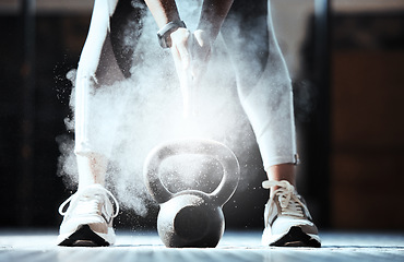 Image showing Fitness, hands and powder at kettlebell in gym for workout, exercise and sports training. Closeup, athlete and legs of bodybuilder with heavy weight equipment, chalk dust and strong performance power