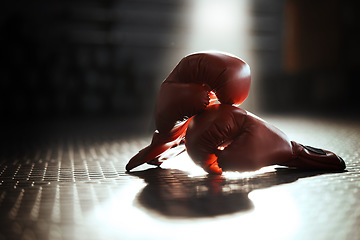 Image showing Gym, background and boxing gloves for fitness, sports and training, wellness and mma competition. Closeup, red boxer glove or fighting sport equipment in empty health center for workout or challenge